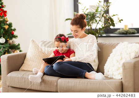 mother and daughter with tablet pc at christmas 44262483