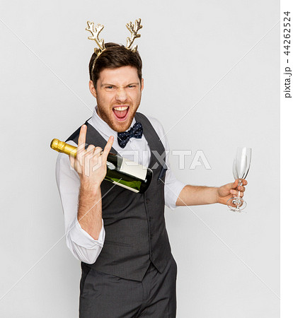 man with bottle of champagne at christmas party man with bottle of champagne at christmas party 44262524