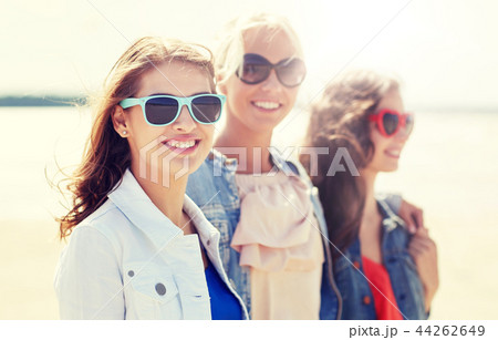 group of smiling women in sunglasses on beach group of smiling women in sunglasses on beach 44262649