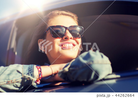 happy teenage girl or young woman in car 44262664
