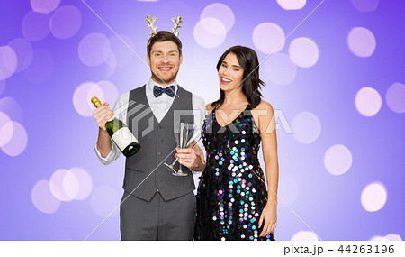 couple with champagne bottle at christmas party 44263196