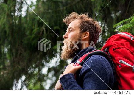 bearded traveler with backpack in woods 44263227
