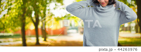 Composite image of woman in winter clothing posing against white background 44263976