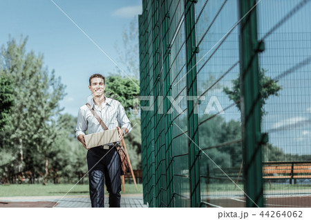 Young male courier offering fast delivery service Young male courier offering fast delivery service 44264062
