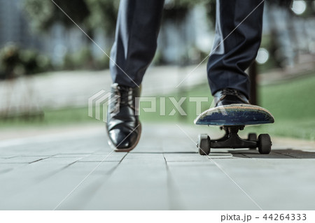 Energetic active man improving skills on skateboard Energetic active man improving skills on skateboard 44264333