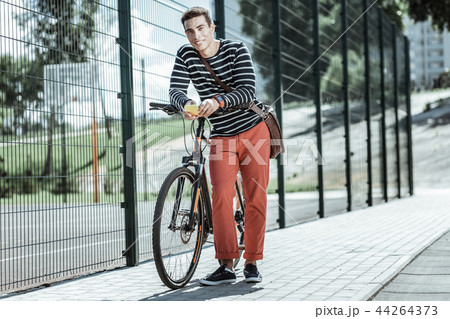 Handsome nice guy liking better bicycle than car 44264373