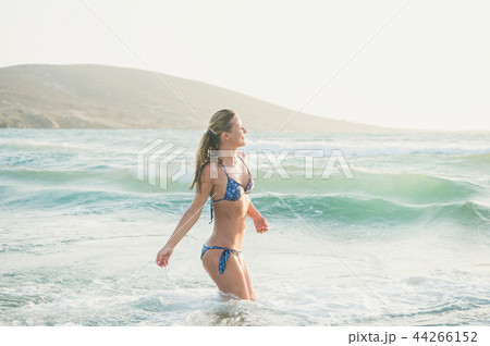Young woman enjoying warm waters of Mediterranean sea, Greece Young woman enjoying warm waters of Mediterranean sea, Greece 44266152