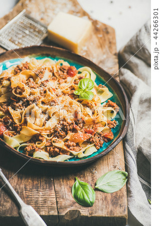 Italian traditional pasta dinner with tagliatelle bolognese and tomato sauce Italian traditional pasta dinner with tagliatelle bolognese and tomato sauce 44266301