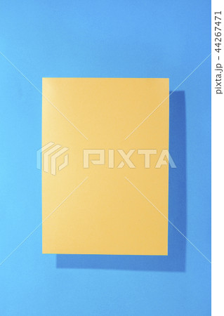 Sheet of yellow paper on a blue background 44267471