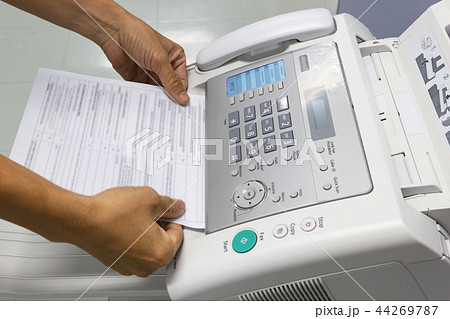 Hand man are using a fax machine in the office 44269787