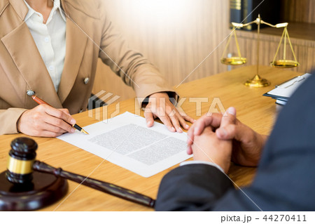 business people and lawyers discussing contract papers sitting a business people and lawyers discussing contract papers sitting a 44270411