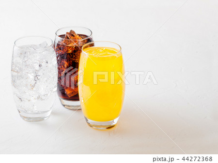 Glasses of soda drink with ice cubes and bubbles 44272368