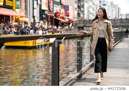businesswoman relaxing and walking beside river businesswoman relaxing and walking beside river 44272506