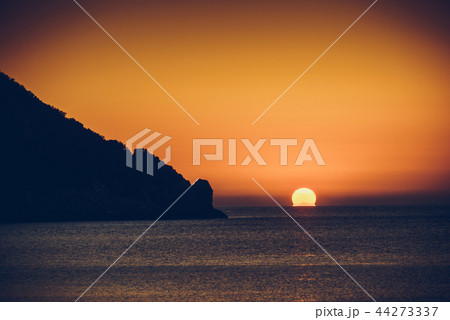 Sunset or sunrise over sea surface Sunset or sunrise over sea surface 44273337