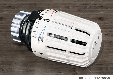 Thermostatic radiator valve on the wooden table Thermostatic radiator valve on the wooden table 44276656