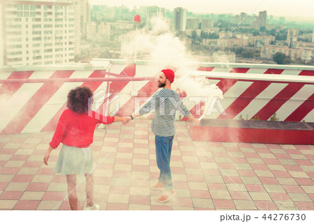 Creative young making surprise for his girlfriend with smoke flare 44276730