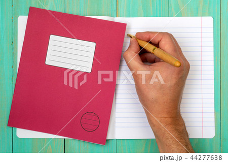 Hand writing in open school notebook 44277638