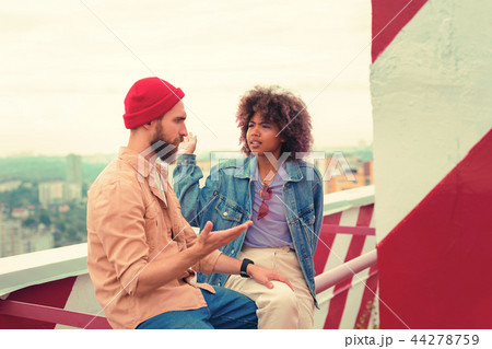Offended girl giving her boyfriend slap in the face while feeling angry Offended girl giving her boyfriend slap in the face while feeling angry 44278759