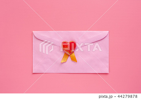 Pink envelope with red heart on pink background 44279878
