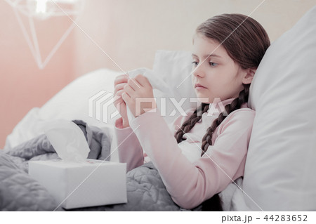 Close up of little sad girl with napkins 44283652