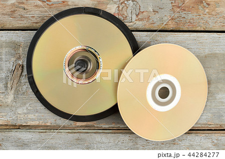 DVD discs on old wooden background. 44284277