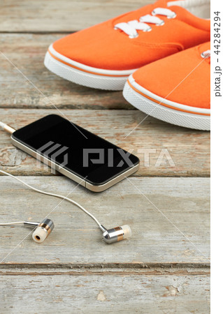 Sport shoes, earphones and smartphone. Sport shoes, earphones and smartphone. 44284294