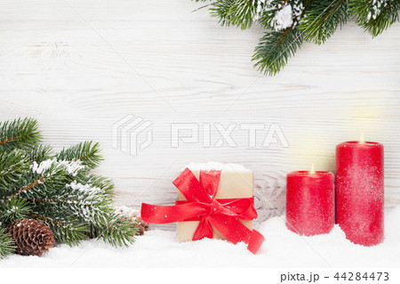 Christmas gift box, candles and fir tree Christmas gift box, candles and fir tree 44284473