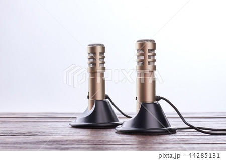 Double stereo microphone on wooden table. Double stereo microphone on wooden table. 44285131