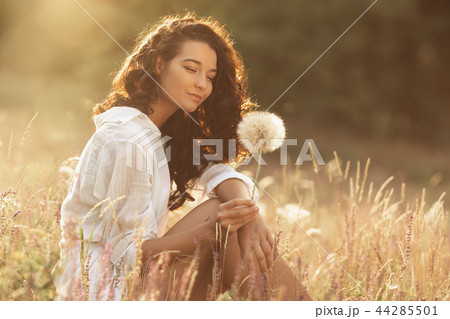 Beautiful carefree woman in fields being happy outdoors 44285501