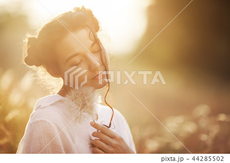 Beautiful carefree woman in fields being happy outdoors 44285502