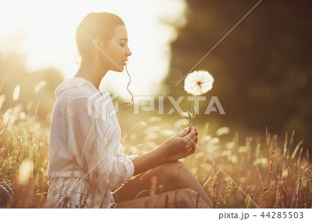 Beautiful carefree woman in fields being happy outdoors 44285503