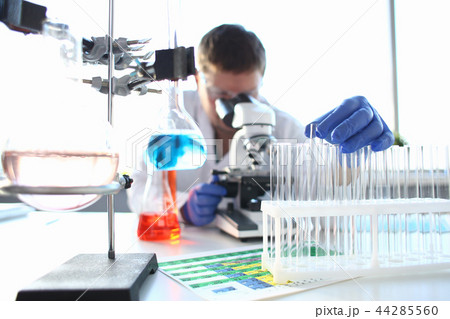 Portrait of a young chemist looking in binocular Portrait of a young chemist looking in binocular 44285560