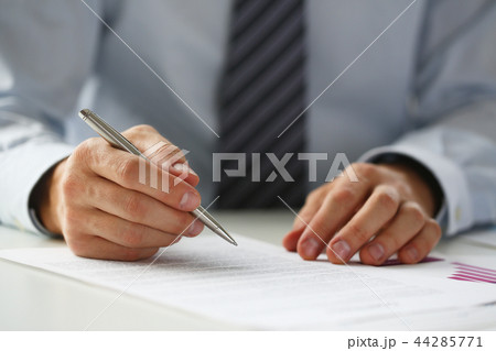 Hand of businessman in suit filling and signing with Hand of businessman in suit filling and signing with 44285771