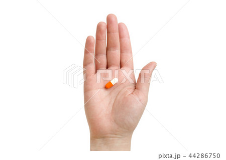 girl holding an orange capsule. Isolated on white background 44286750