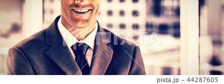 Smiling businessman in his office Smiling businessman in his office 44287605
