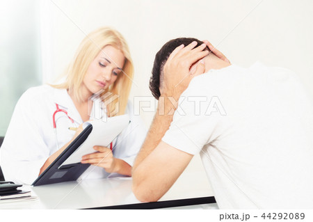 Woman Doctor and Male Patient in Hospital Office Woman Doctor and Male Patient in Hospital Office 44292089