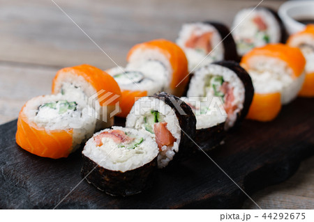 Japanese sushi rolls served on wooden tray Japanese sushi rolls served on wooden tray 44292675