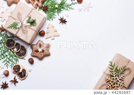 gingerbread cookies and gift box on white table 44292697