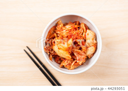 Kimchi cabbage in bowl with chopsticks on wooden 44293051