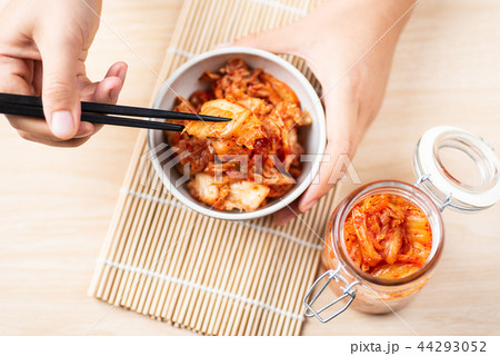 Hand holding chopsticks for eating kimchi cabbage 44293052