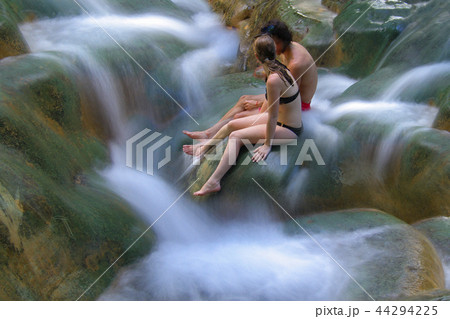 waterfall and leg of woman enjoy in the water 44294225