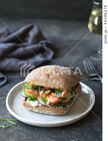Sandwich with roasted salmon, arugula, avocado Sandwich with roasted salmon, arugula, avocado 44296276