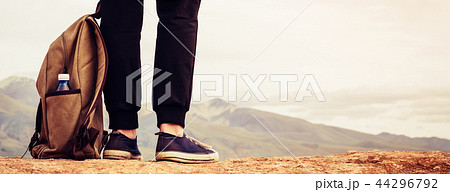 Girl tourist in sneakers stands on mountain 44296792