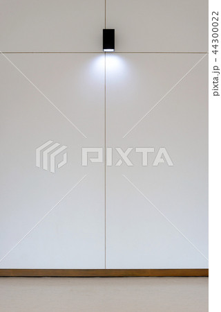 Model lamp on wooden wall in room 44300022