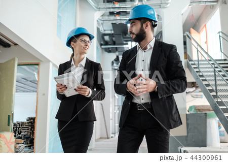 Engineers in hardhats have conversation Engineers in hardhats have conversation 44300961