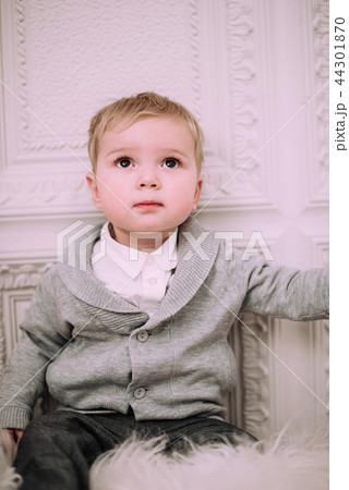 Cheerful little baby boy playing near Christmas tree Cheerful little baby boy playing near Christmas tree 44301870