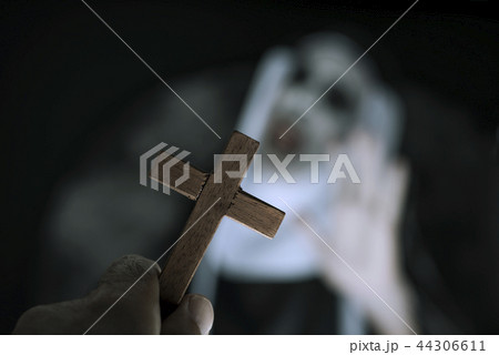 frightening evil nun screaming in front of a cross frightening evil nun screaming in front of a cross 44306611