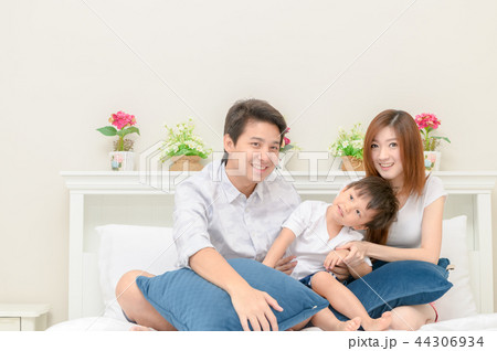 Asian happy family on white bed in the bedroom Asian happy family on white bed in the bedroom 44306934