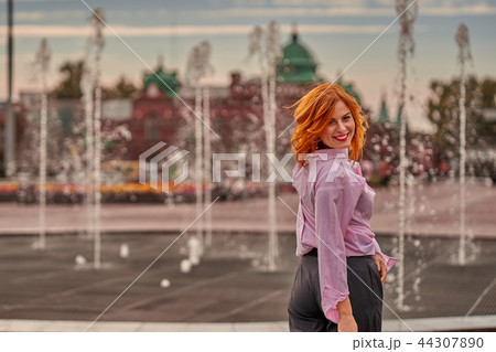Portrait of a young beautiful woman with red hair 44307890