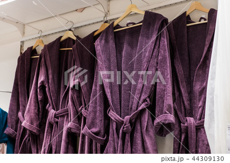 Modern bathrobe clothes collection hang on a shelf in a designer clothes store. Lifestyle home 44309130